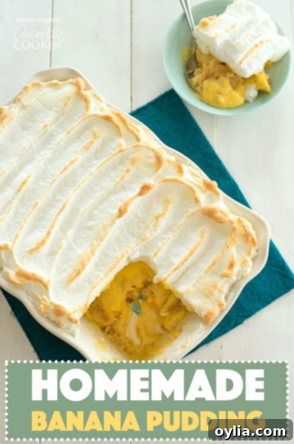 Grandma's Homemade Banana Pudding 7 A large pan of homemade banana pudding with a golden meringue, a slice has been removed to reveal creamy layers beneath