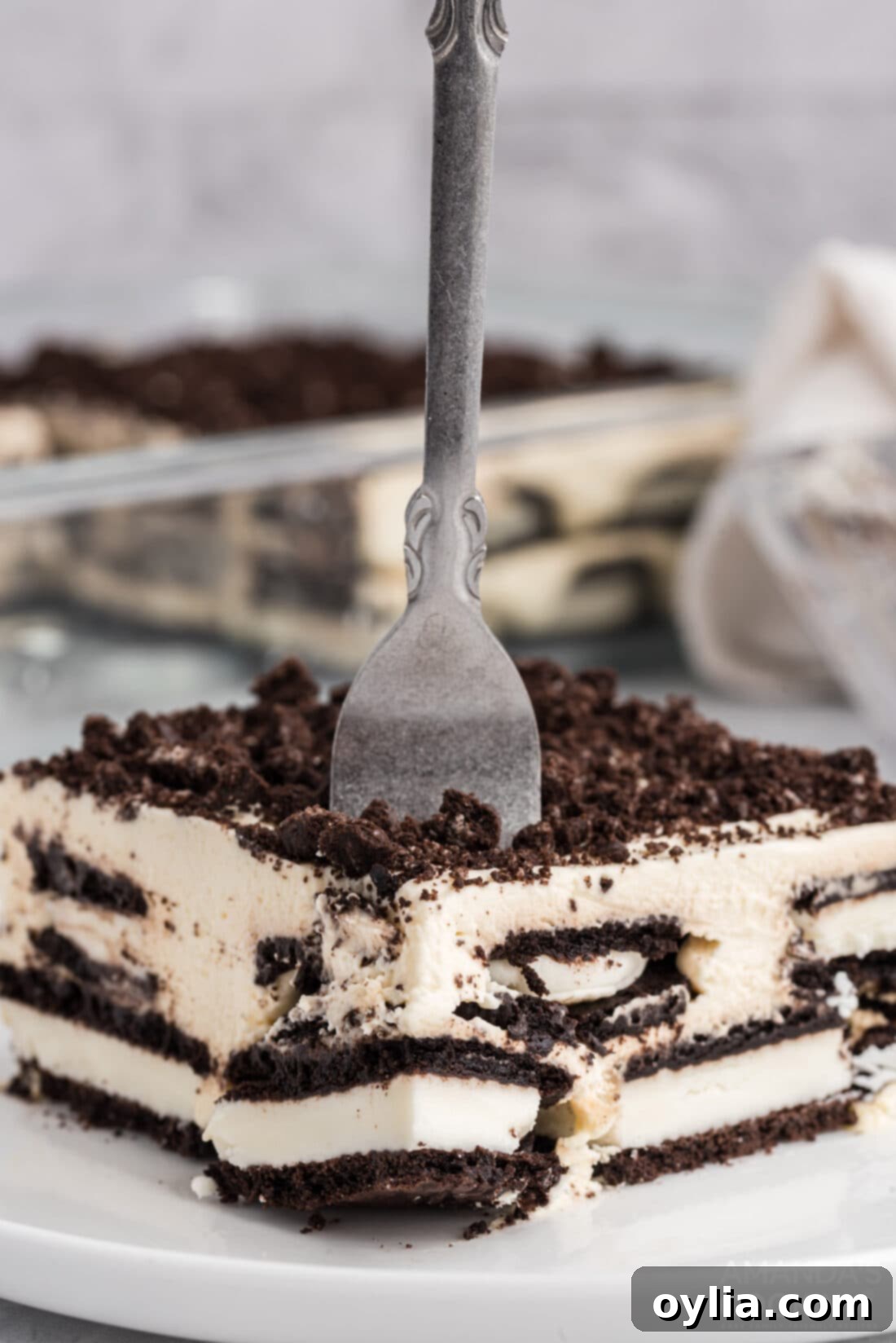 Effortless Oreo Dream Cake 3 fork poked into Oreo Icebox Cake