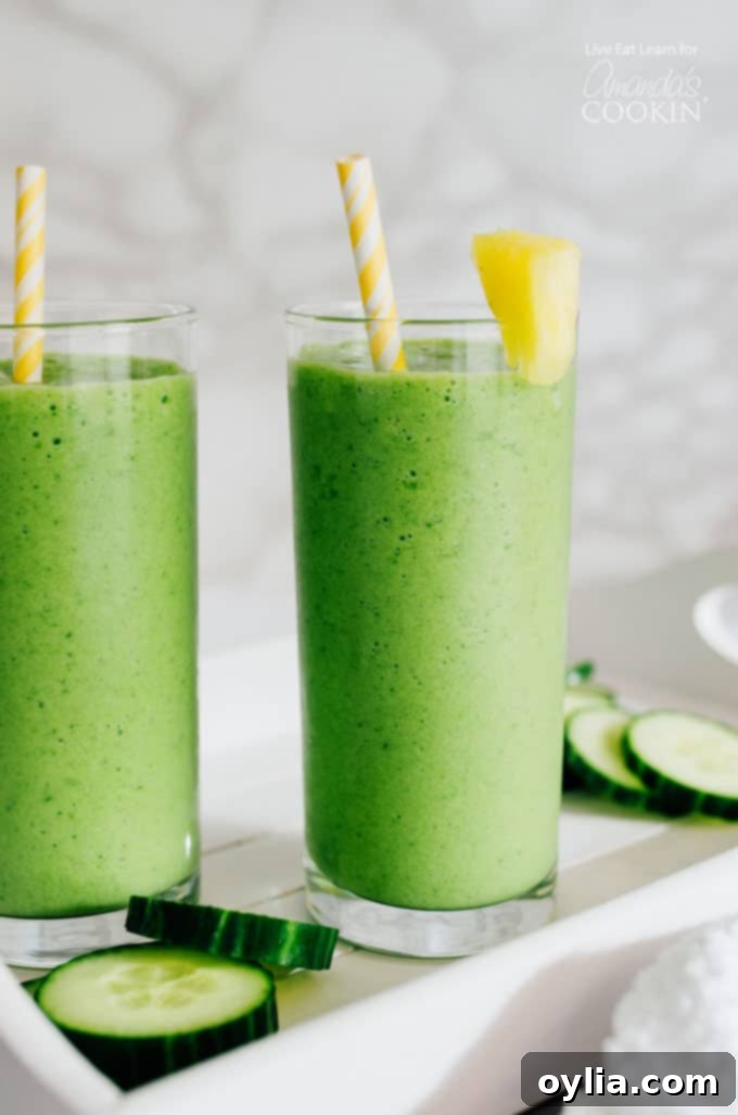 Cucumber Tropical Smoothies in glass with pineapple garnish