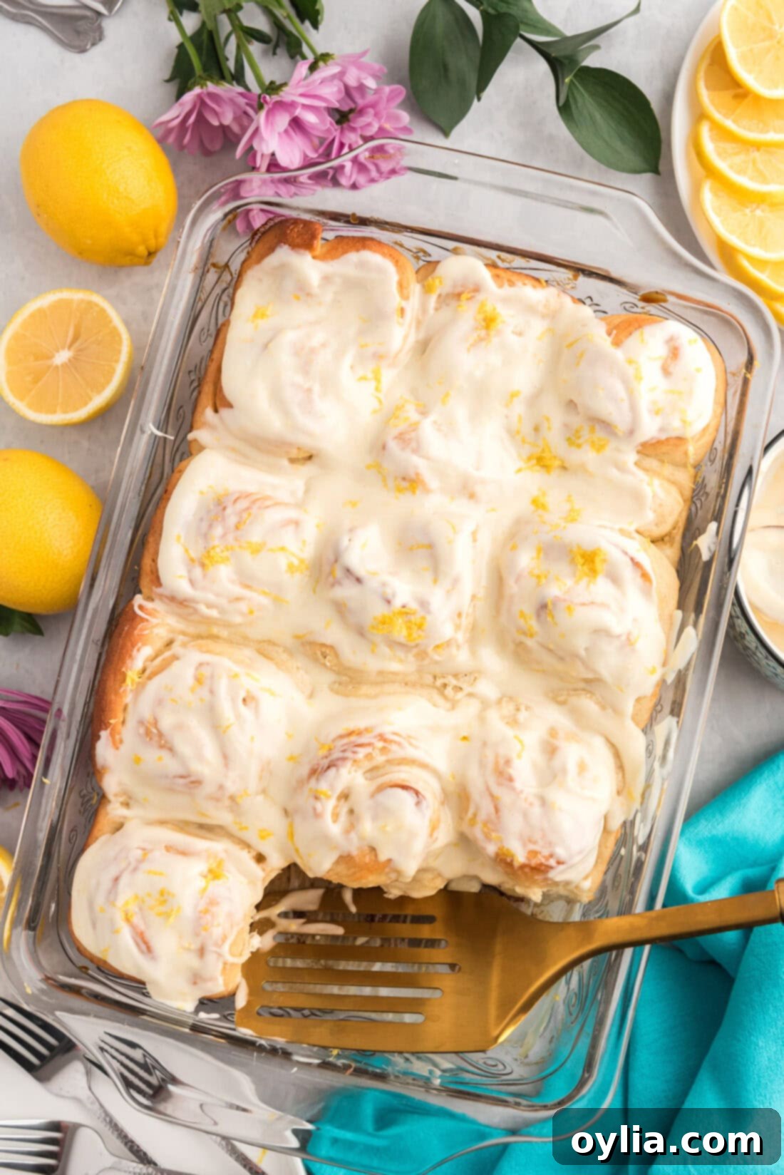 Sunshine Lemon Sweet Rolls 2 Pan of Lemon Sweet Rolls with a spatula in it