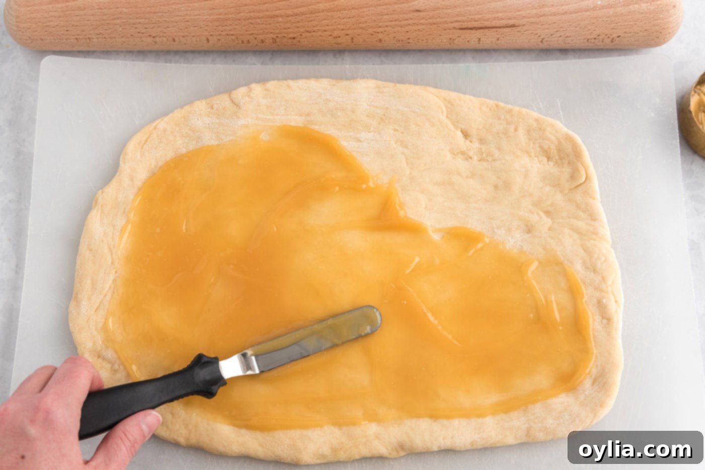 lemon curd spread over dough