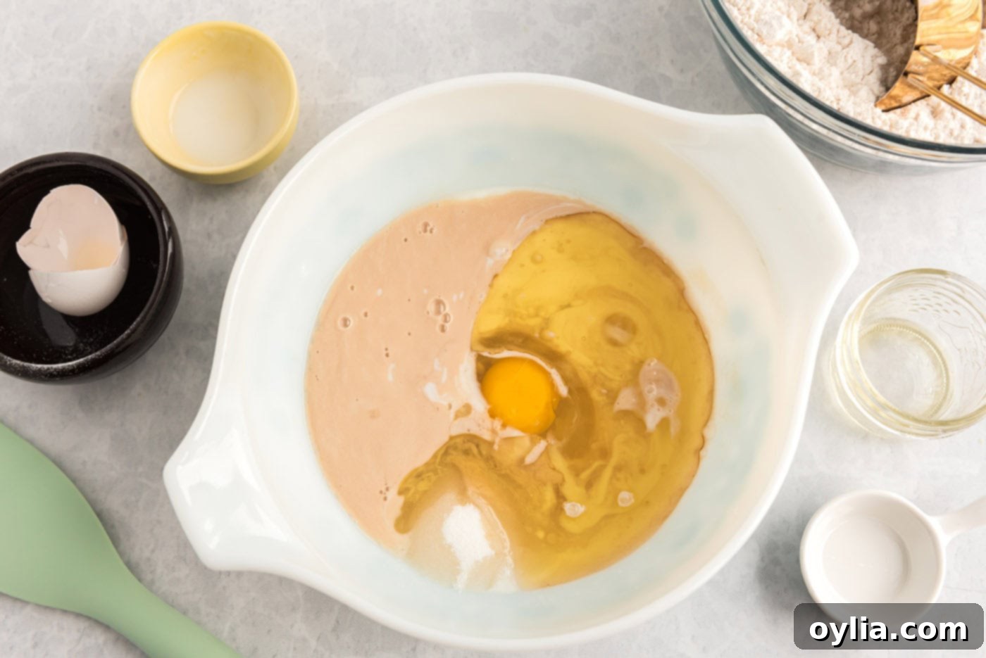 sugar, buttermilk, egg, and oil added to lemon sweet roll dough in a bowl