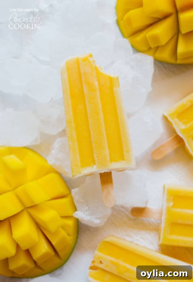 Mango Yogurt Popsicle with bite missing, showcasing creamy texture
