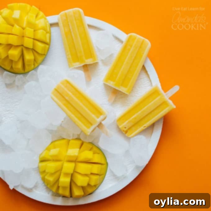 Mango Yogurt popsicles on a plate of ice, beautifully arranged
