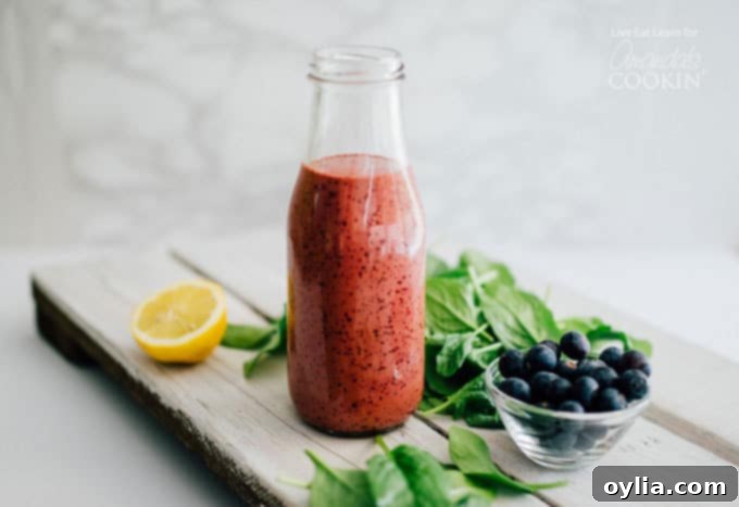 Blueberry vinaigrette dressing stored in a milk bottle, showing its smooth, emulsified texture, ready to be served.