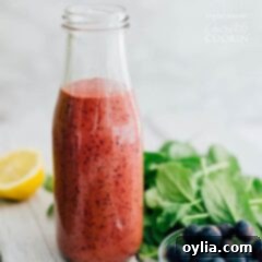 Blueberry Vinaigrette in a milk bottle, showcasing its rich purple color and smooth texture.