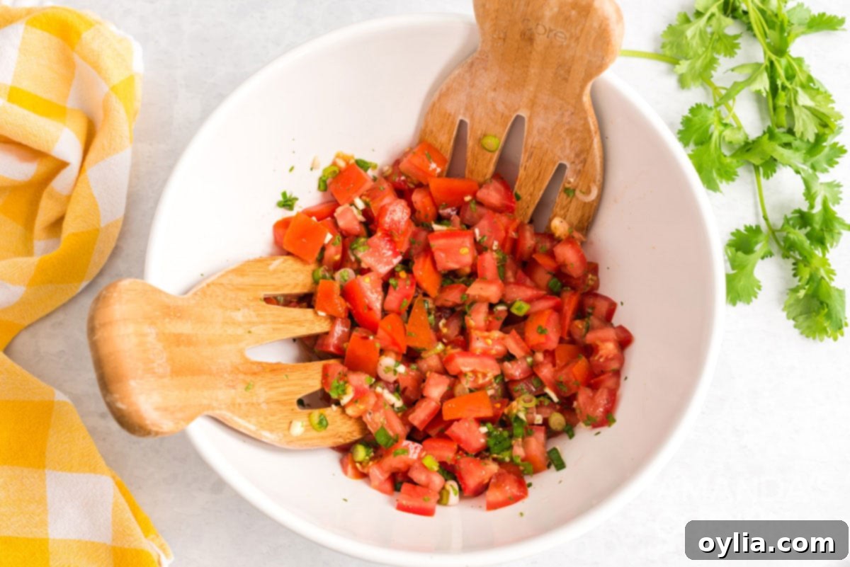 salsa fresca with salad tossing spoons