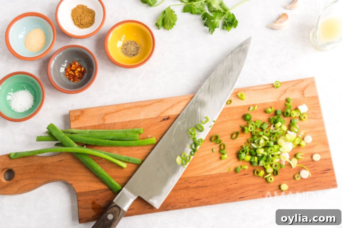 chopped green onions and a knife on cutting board
