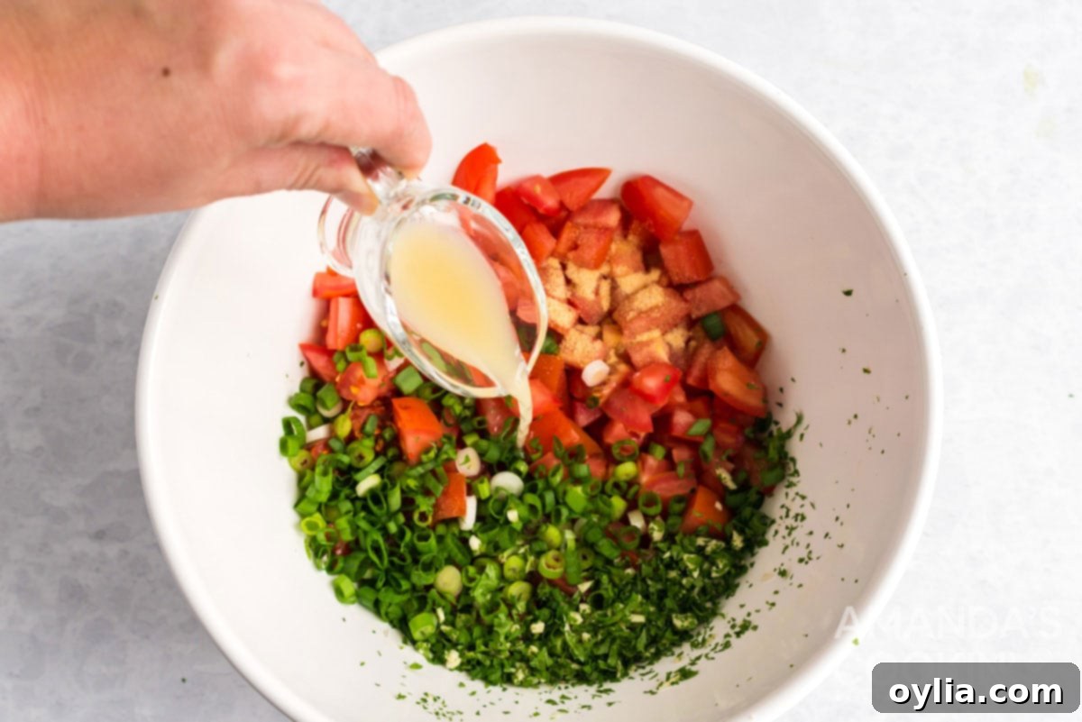 adding lime juice to salsa fresca ingredients in bowl