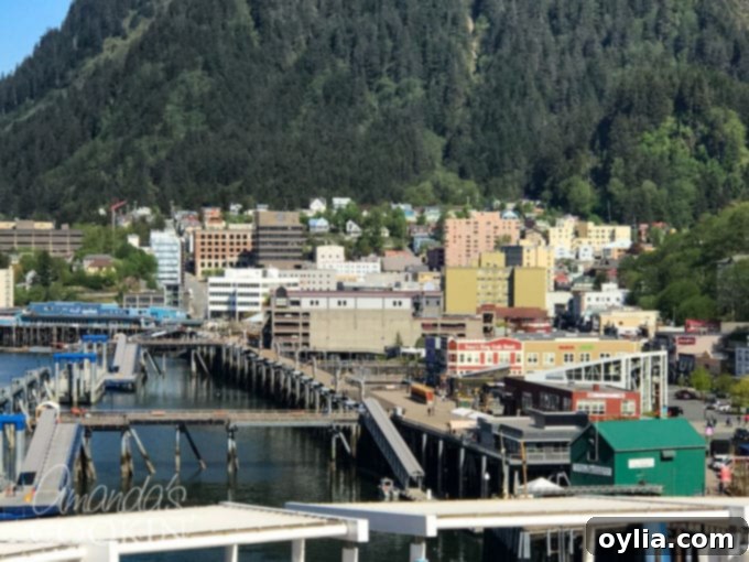 Panoramic view of Juneau, Alaska with cruise ships docked and mountains in the background