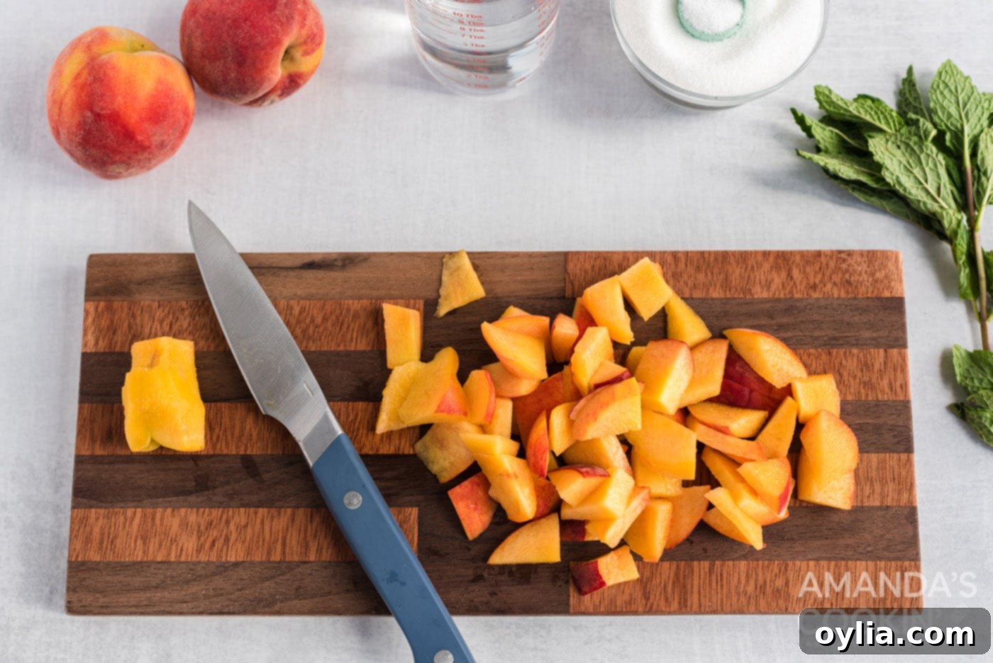 Sliced peaches on a cutting board, ready for preparation.