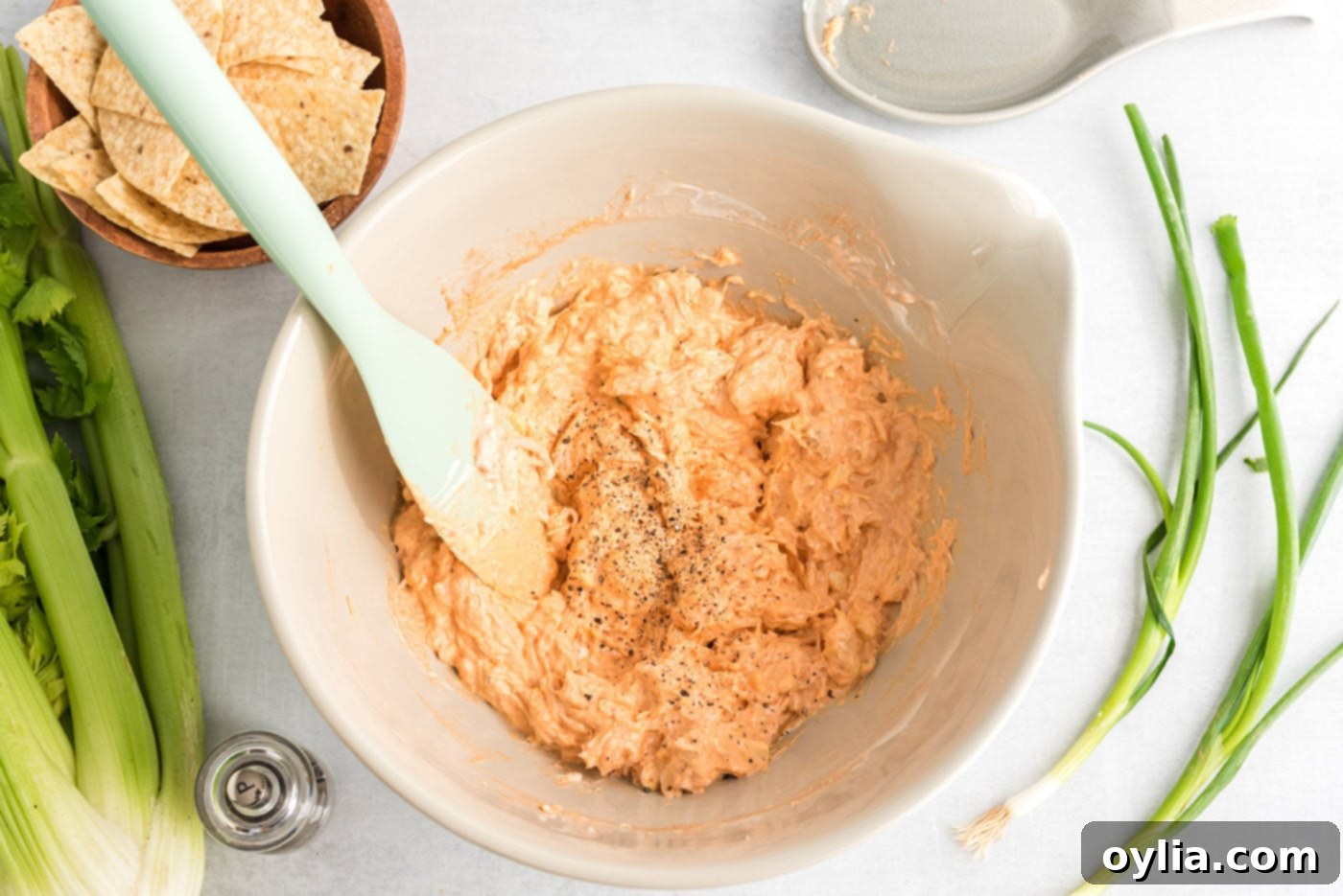 rubber spatula mixing buffalo chicken dip