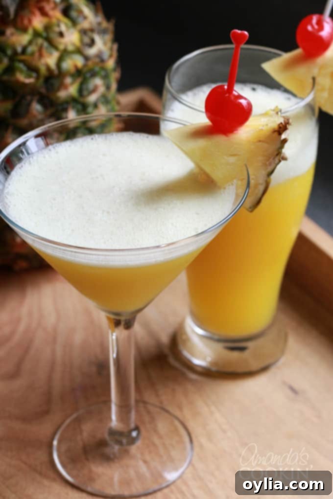 Rum cocktail in a martini glass with pineapple garnish