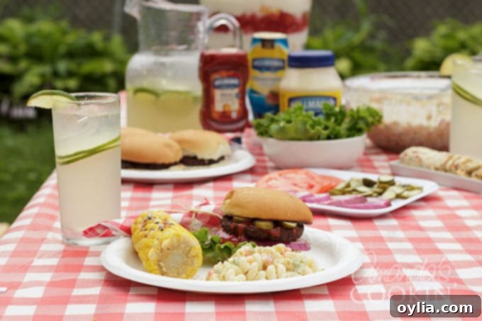 Beautifully arranged backyard barbecue spread with grilled food, sides, and drinks.
