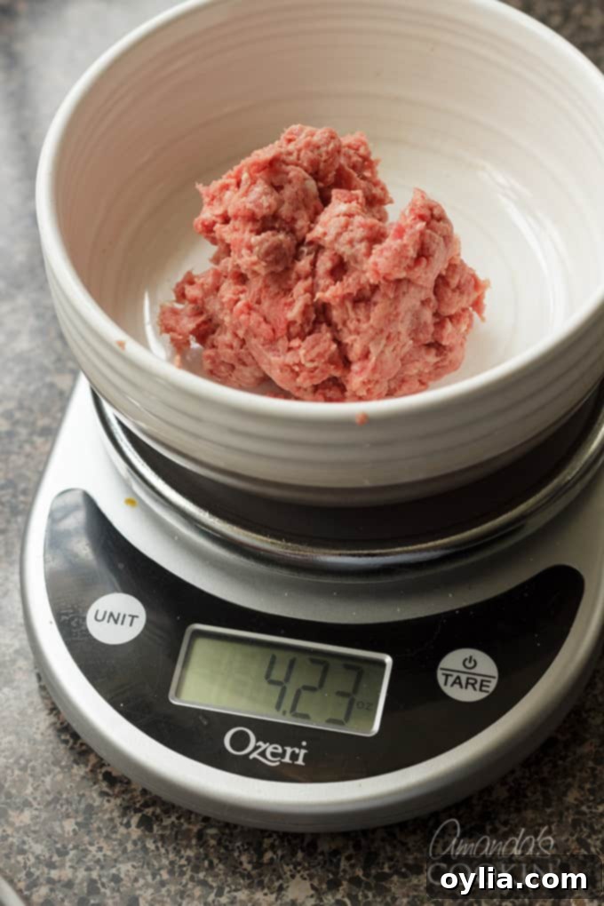 Close-up of ground beef on a kitchen scale showing the weight.