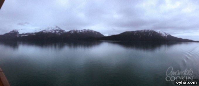 Breathtaking night view of Alaska's Glacier Bay with reflections on calm water, capturing the serene beauty of the region.