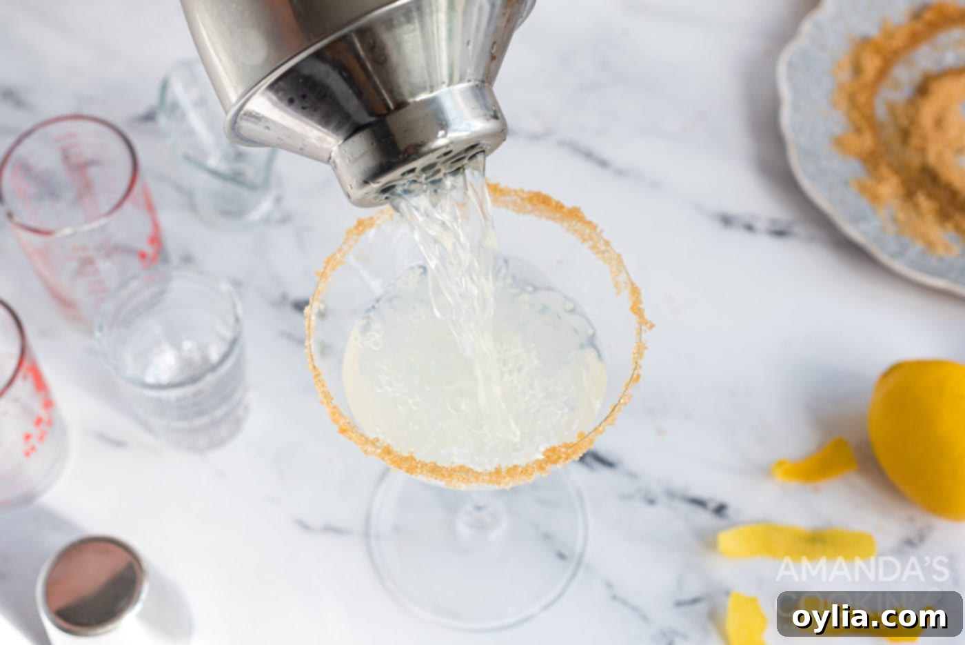 cocktail shaker pouring into martini glass