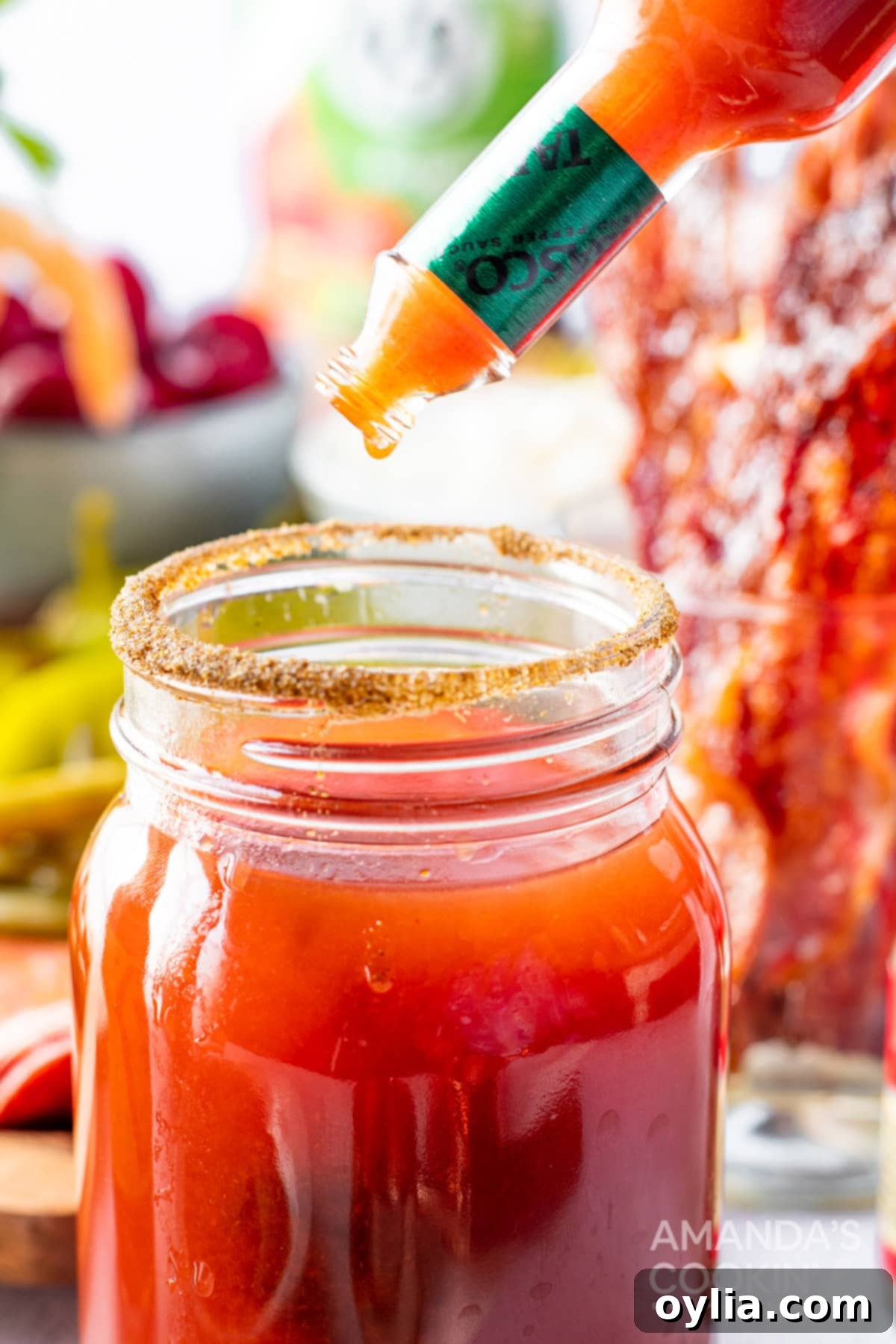 adding hot sauce to glass