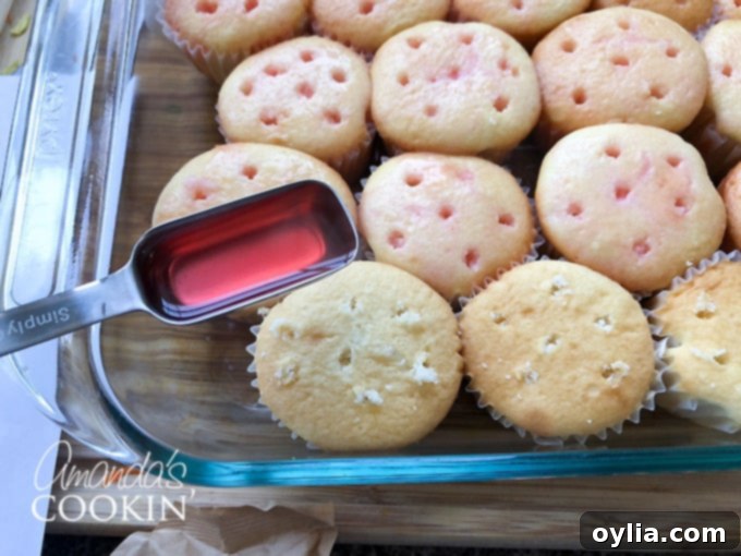 Spoon Jello mixture over poked cupcakes