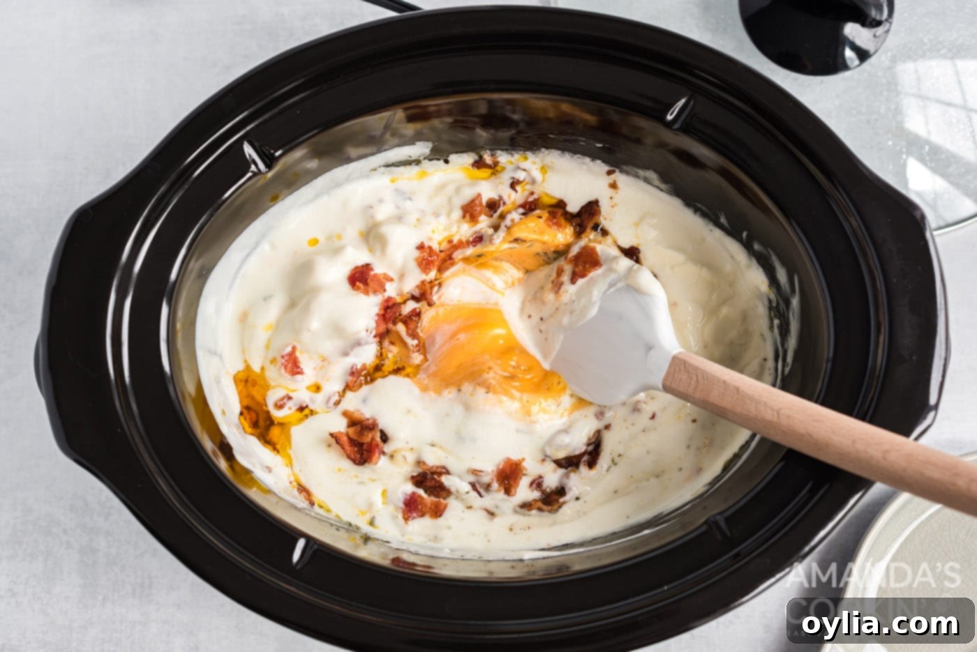 stirring crockpot cheese dip