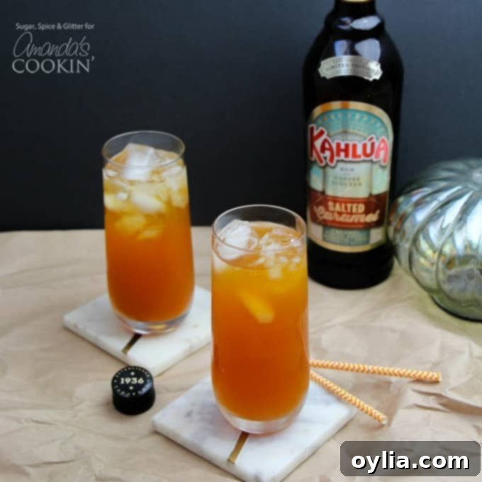 Two tall caramel pumpkin cocktails with Kahlua in the background, perfect for a fall gathering.