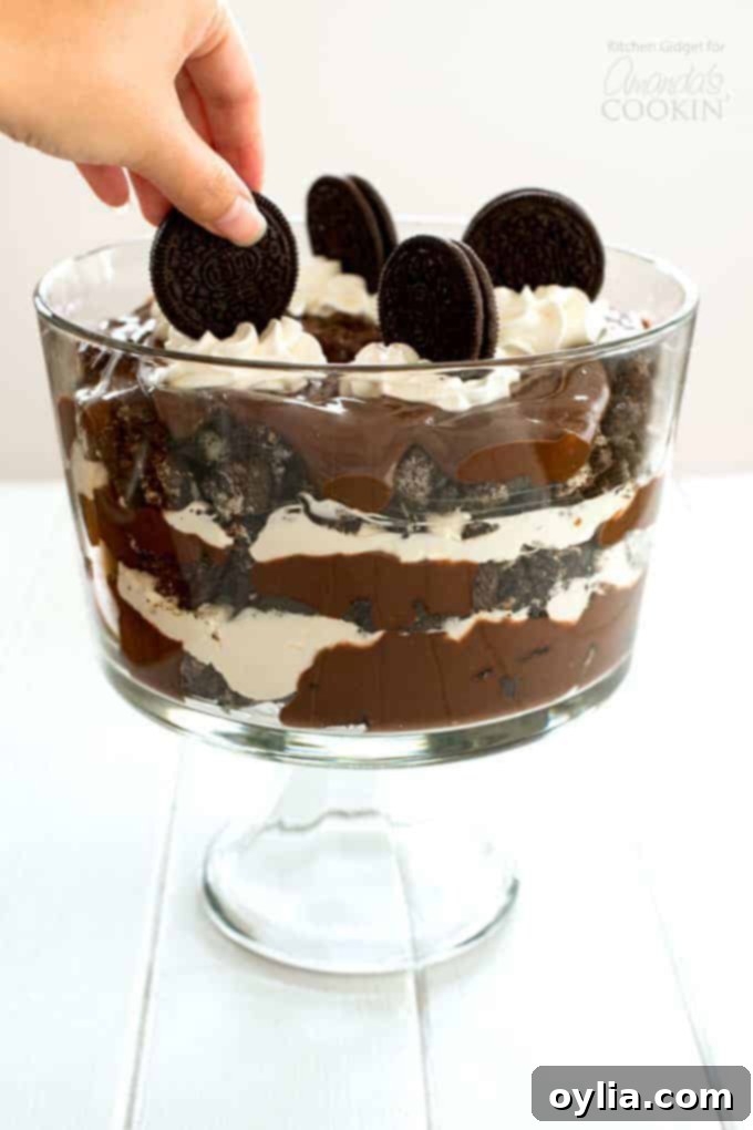 Placing an oreo on top of Chocolate Lasagna Trifle