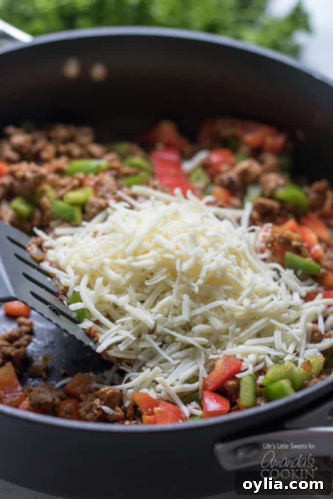cheese being added to skillet