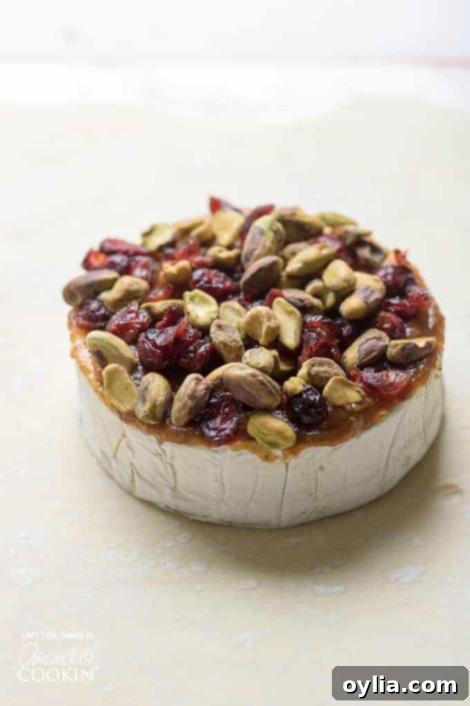 Brie cheese with fruit, nuts, and jam
