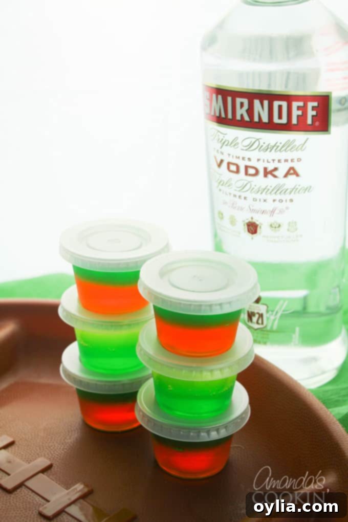 Individual plastic containers filled with layered football jello shots