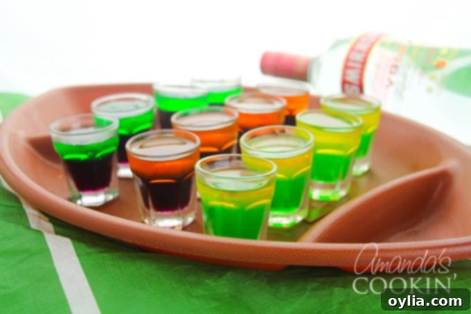 Assorted football team jello shots in plastic containers on a platter