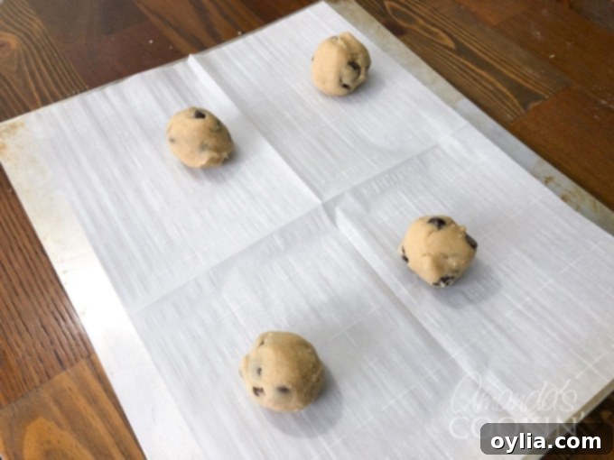 Chocolate chip cookie dough prepared on a baking sheet