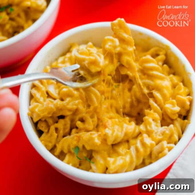 A vibrant bowl of Butternut Squash Pasta, garnished with fresh herbs and a hint of spice, ready to be enjoyed.