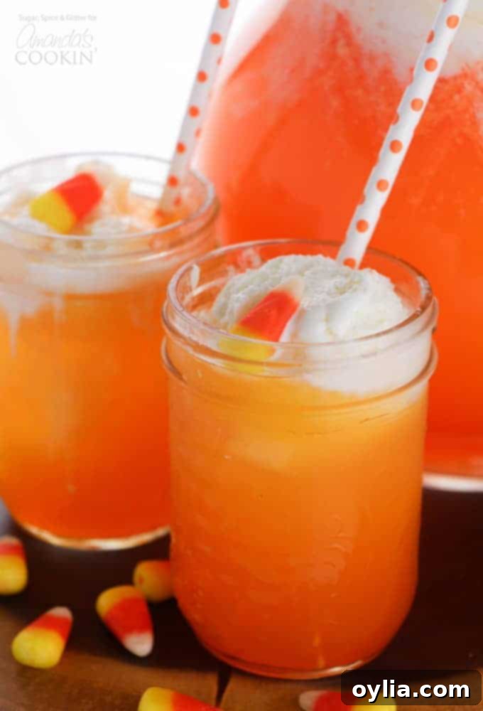 Candy corn punch in a glass with straws