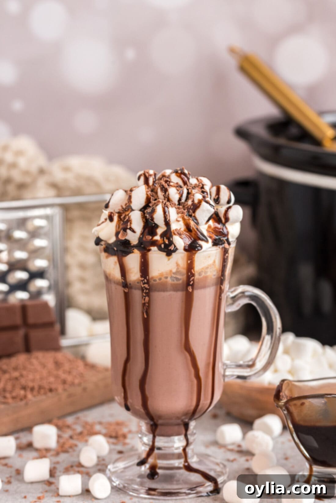 Crockpot Hot Chocolate in a mug topped with marshmallows and chocolate drizzle