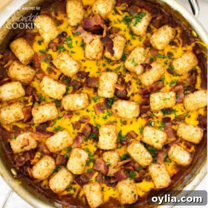BBQ Chicken Tater Tot Skillet garnished with crispy bacon