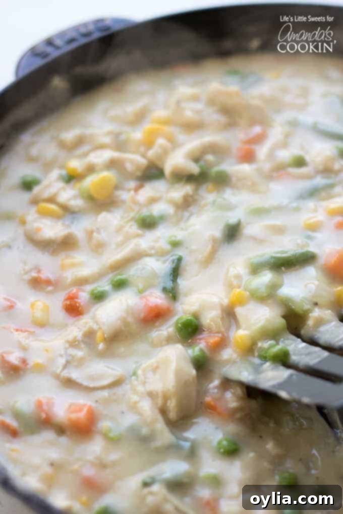 Cooking the creamy filling for Chicken Pot Pie Tater Tot Casserole on the stovetop
