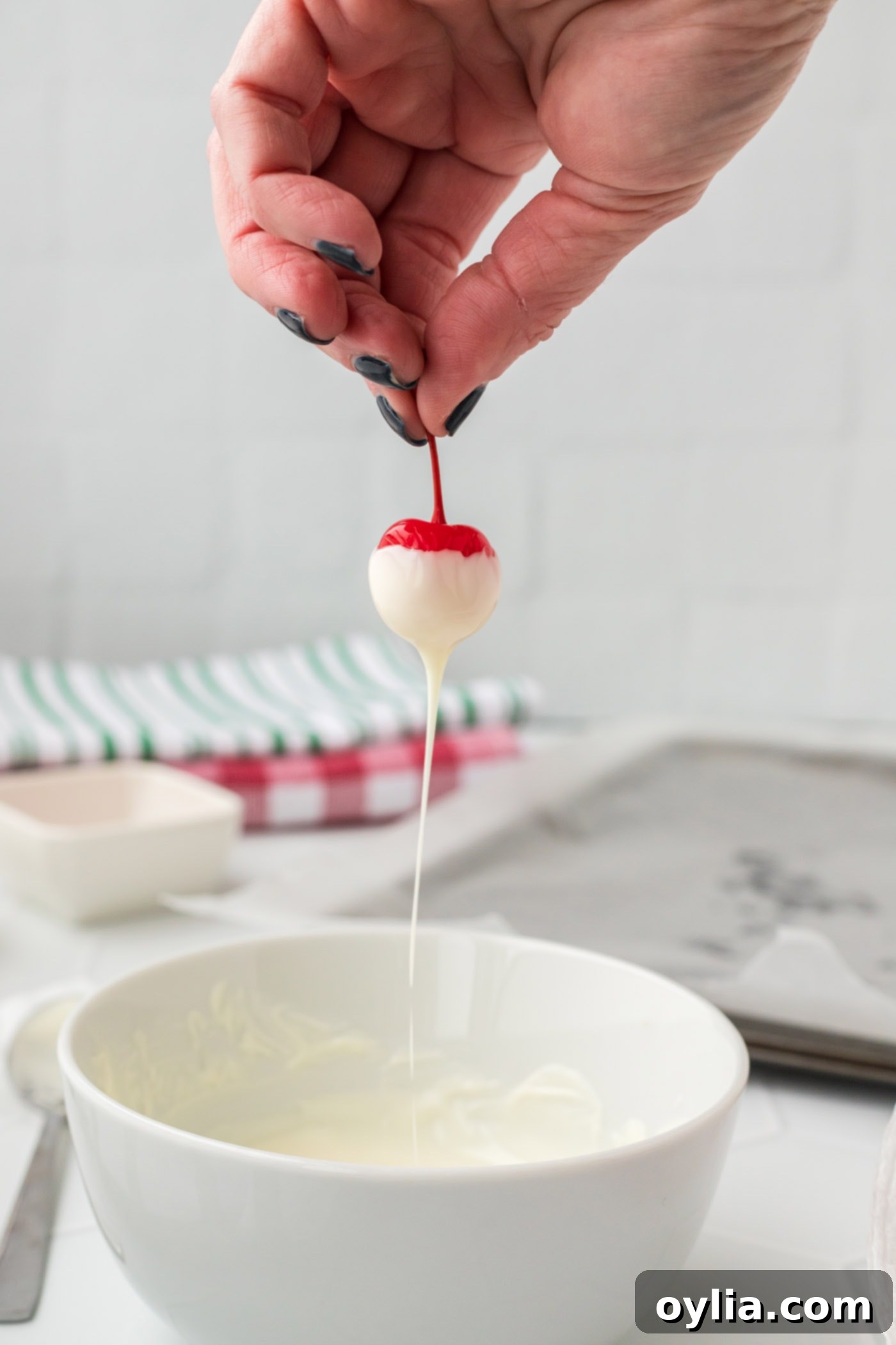 dipping boozy cherry into chocolate