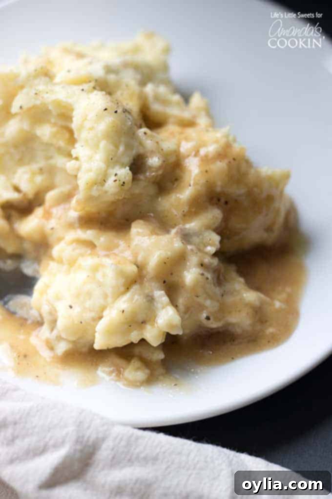 Creamy Traditional Mashed Potatoes Final presentation of creamy traditional mashed potatoes, garnished with fresh herbs