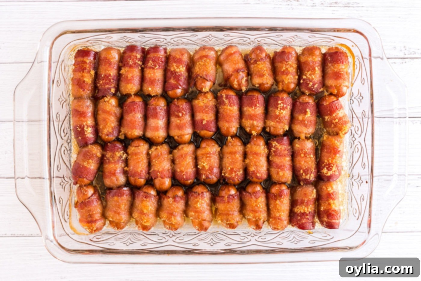 Bacon Wrapped Little Smokies in a pan, baked to a golden, crispy perfection with caramelized sugar