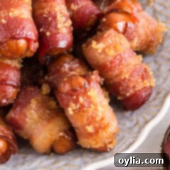 Close up photo of Bacon Wrapped Little Smokies on a plate, showing the rich caramelization