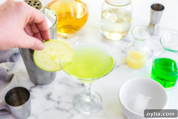 placing apple wheel slice on edge of martini glass