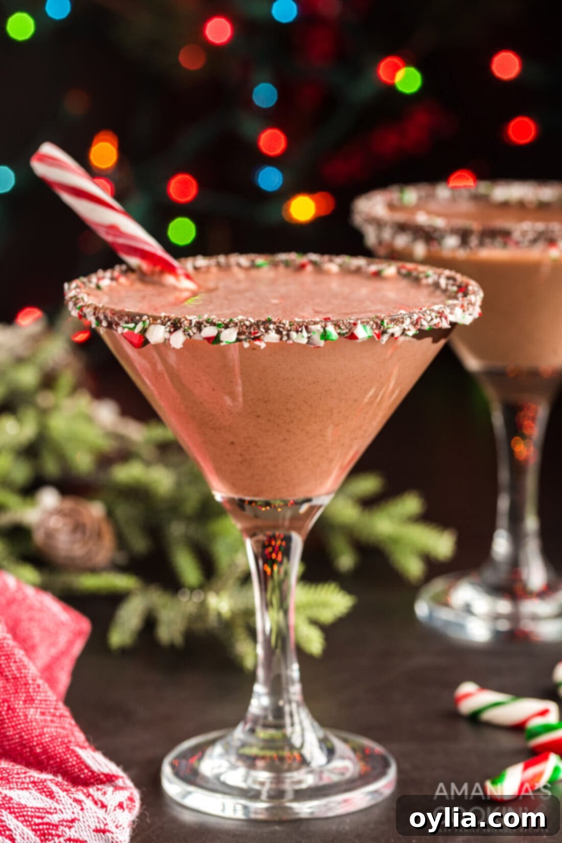 A trio of delicious chocolate peppermint martinis garnished with candy canes and cream swirls, set against a festive backdrop.