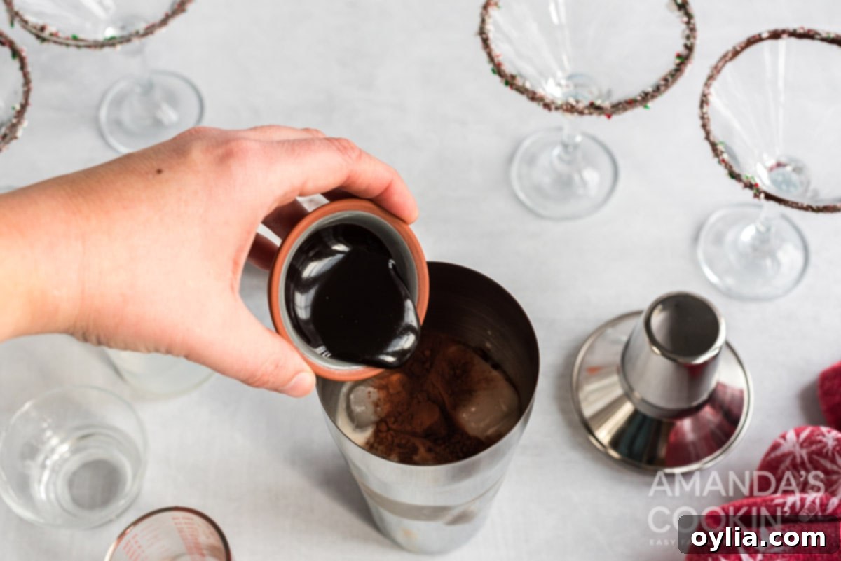 Adding chocolate liquor, cream, peppermint vodka, cocoa powder, and chocolate syrup to a cocktail shaker filled with ice.