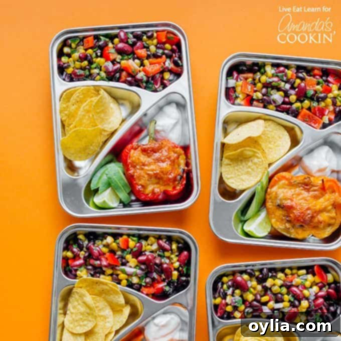 Portioned stuffed pepper and bean salad lunches in silver meal prep containers