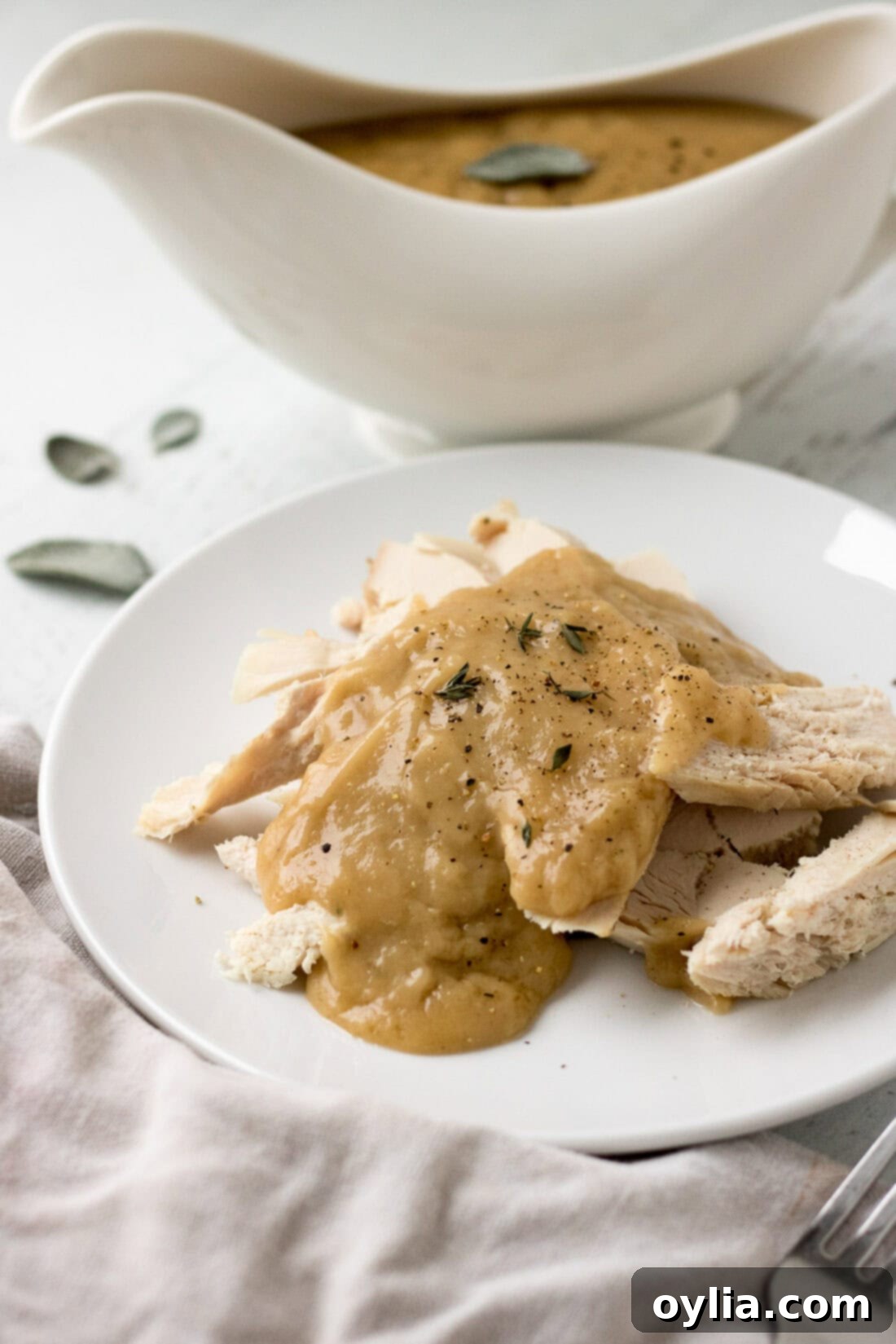 The Ultimate Homemade Turkey Gravy 3 Homemade Turkey Gravy generously poured over sliced turkey on a festive plate