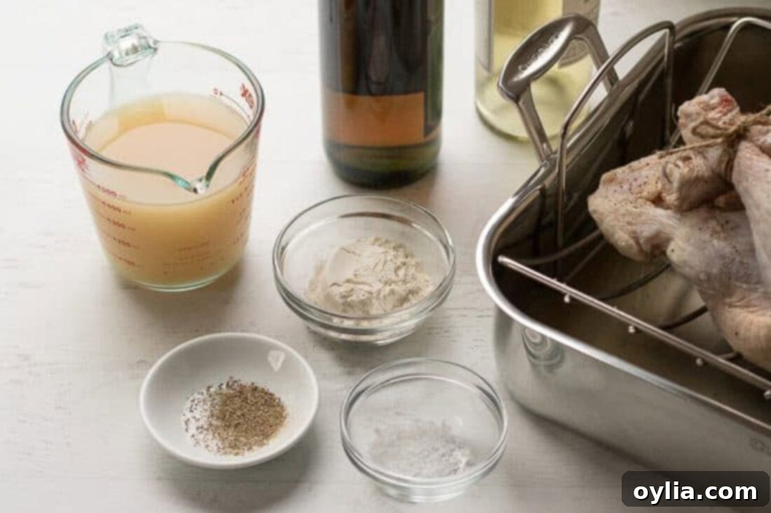 The Ultimate Homemade Turkey Gravy 4 A collection of ingredients laid out for making Homemade Turkey Gravy, including herbs, broth, and flour