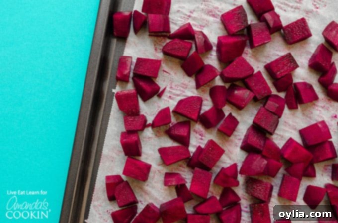 Roasted beets on a baking sheet, ready to be added to the salad