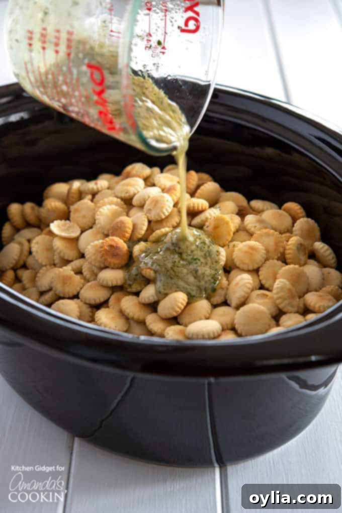 Ranch Seasoned Oyster Crackers- pouring seasoning over crackers
