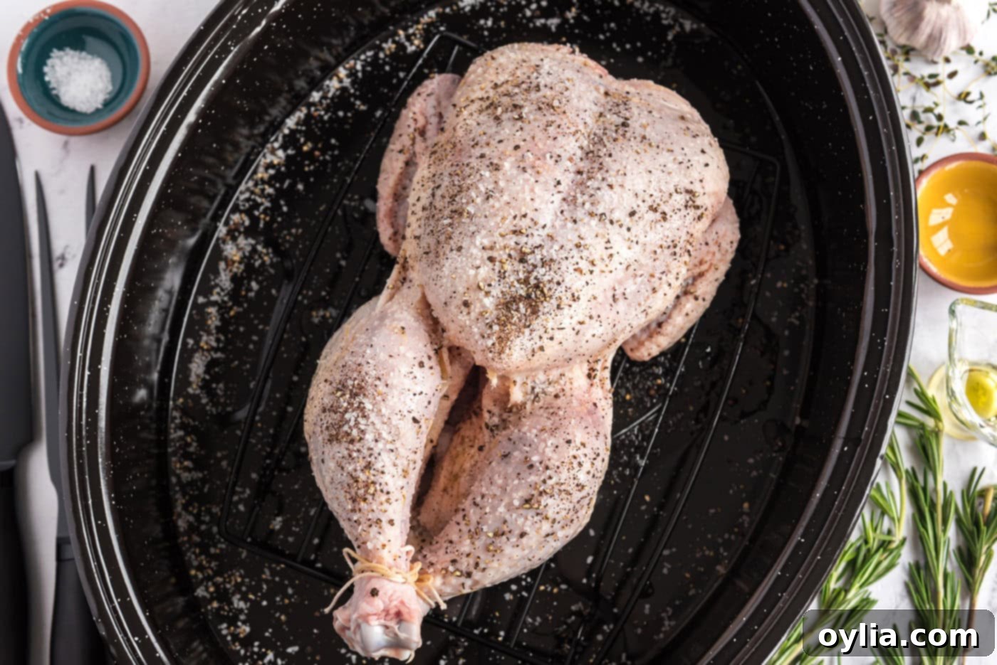 whole raw chicken rubbed with olive oil, salt, and pepper