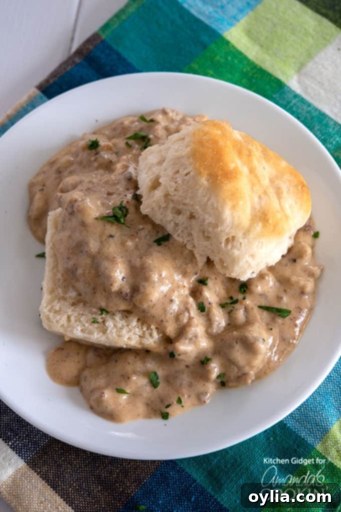 Sausage gravy generously spooned over fluffy biscuits, ready to be served